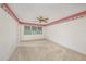 Spacious bedroom featuring neutral carpet, a ceiling fan, and a window for natural light at 5980 80Th N St # 410, St Petersburg, FL 33709
