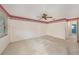 Bedroom featuring neutral carpet, a ceiling fan, with an attached door to the hallway at 5980 80Th N St # 410, St Petersburg, FL 33709