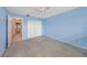Bedroom featuring neutral carpet, a ceiling fan, and a closet for ample storage at 5980 80Th N St # 410, St Petersburg, FL 33709