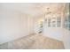 Dining area with view into kitchen, chandelier, and mirrored wall accent at 5980 80Th N St # 410, St Petersburg, FL 33709