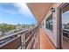 Condo exterior featuring a long balcony with metal railing and exterior light at 5980 80Th N St # 410, St Petersburg, FL 33709