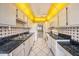 Galley-style kitchen with white cabinetry, black countertops and ceiling fan at 5980 80Th N St # 410, St Petersburg, FL 33709