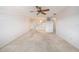 Spacious living room featuring neutral walls, carpet, and a ceiling fan at 5980 80Th N St # 410, St Petersburg, FL 33709