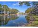Scenic view of a serene pond with fountains, surrounded by lush trees and well-maintained buildings at 5980 80Th N St # 410, St Petersburg, FL 33709