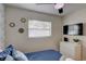 Bedroom with a double bed, TV, and ample natural light at 6407 S Clark Ave, Tampa, FL 33616