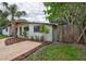 Updated mid-century home with a large yard and wooden fence at 6407 S Clark Ave, Tampa, FL 33616