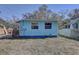 Backyard view of the house with a small deck and fenced yard at 6532 30Th N St, St Petersburg, FL 33702