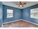 Bedroom with hardwood floors, ceiling fan, and natural light from two windows at 6532 30Th N St, St Petersburg, FL 33702