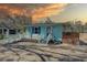 Charming blue house with a spacious brick driveway and inviting front porch at 6532 30Th N St, St Petersburg, FL 33702