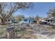 Charming blue home with a front porch and brick driveway, surrounded by trees and other houses at 6532 30Th N St, St Petersburg, FL 33702