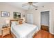 Comfortable bedroom featuring a queen-sized bed, ceiling fan, and hardwood floors at 7882 Sailboat Key S Blvd # 508, South Pasadena, FL 33707