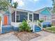 Beautiful home featuring a screened-in porch and steps to a bright blue entrance at 809 E New Orleans Ave, Tampa, FL 33603