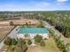 Aerial view of a multi-story building surrounded by green trees and manicured lawns at 8150 Southern Pines Dr, Brooksville, FL 34601