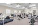 Spacious gym with several exercise machines, multiple ceiling fans, and natural light at 8150 Southern Pines Dr, Brooksville, FL 34601