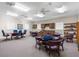 Inviting community meeting room offering tables, seating, and built-in kitchenette area at 8150 Southern Pines Dr, Brooksville, FL 34601