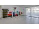 Spacious basement boasts clean, epoxy floors and glass sliding doors to the backyard at 9347 Blind Pass Rd, St Pete Beach, FL 33706