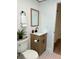 Charming bathroom featuring a stylish vanity with wood grain cabinets, a modern sink, and eye-catching patterned floors at 9987 85Th Way, Seminole, FL 33777