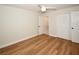 Bedroom with wood-look flooring, closet, and door to bathroom at 9987 85Th Way, Seminole, FL 33777