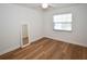 Bright bedroom featuring wood-look floors, a ceiling fan, and a mirror at 9987 85Th Way, Seminole, FL 33777