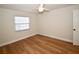 Bright bedroom featuring wood-look floors, a ceiling fan, and a window at 9987 85Th Way, Seminole, FL 33777