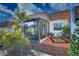 Charming exterior view of a home with a sunroom that leads to an outdoor patio, surrounded by lush landscaping at 9987 85Th Way, Seminole, FL 33777