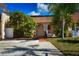 Inviting single-story home boasting an arched entryway, tiled roof, lush landscaping, and a quaint walkway at 9987 85Th Way, Seminole, FL 33777
