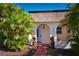 Beautiful single-story home with lush landscaping, an arched entryway, a tiled roof, and a welcoming pathway at 9987 85Th Way, Seminole, FL 33777