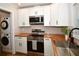 Modern kitchen features stainless appliances, butcher block counters, and stacked washer/dryer at 9987 85Th Way, Seminole, FL 33777