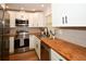Updated kitchen with stainless steel appliances, butcher block countertops, and white cabinetry at 9987 85Th Way, Seminole, FL 33777