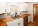 Bright kitchen with butcher block counters, stainless dishwasher and new cabinetry at 9987 85Th Way, Seminole, FL 33777