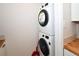 Close-up of the stacked laundry machines, a useful addition to the home at 9987 85Th Way, Seminole, FL 33777