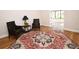 Living room showcases hardwood floors, classic furnishing, neutral walls, and a patterned area rug at 9987 85Th Way, Seminole, FL 33777