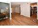 Bright and airy living space featuring hardwood floors, neutral walls, an adjacent kitchen, and modern finishes at 9987 85Th Way, Seminole, FL 33777