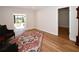 Bright living space with hardwood floors, neutral walls, classic furnishing, and an attached sunroom with green view at 9987 85Th Way, Seminole, FL 33777