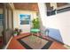 Inviting outdoor patio featuring sleek outdoor furniture set atop a patterned rug surrounded by plants at 9987 85Th Way, Seminole, FL 33777