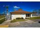 Welcoming pool house with a bright exterior, set amidst neatly trimmed bushes, offering a glimpse into the community pool area at 9987 85Th Way, Seminole, FL 33777