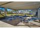 Relaxing poolside seating area with tables and chairs, perfect for enjoying the outdoor community space at 9987 85Th Way, Seminole, FL 33777