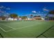Well-maintained tennis court with green surface and white lines, perfect for recreational play at 9987 85Th Way, Seminole, FL 33777