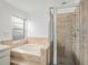 Bathroom features include a garden tub and separate glass shower at 1009 Hardwood Dr, Valrico, FL 33596