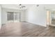 Serene bedroom with hardwood floors, ceiling fan, and sliding door access to the backyard at 1009 Hardwood Dr, Valrico, FL 33596