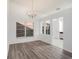 Elegant dining room features hardwood floors, bright windows, and stylish chandelier at 1009 Hardwood Dr, Valrico, FL 33596