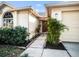 Inviting home entrance with lush landscaping leading to a warm wood door at 1009 Hardwood Dr, Valrico, FL 33596