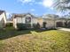 Charming single-story home featuring a well-manicured lawn, arched window, and attached two-car garage at 1009 Hardwood Dr, Valrico, FL 33596