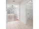 Bright hallway showcasing tile floors and access to the laundry room and living space at 1009 Hardwood Dr, Valrico, FL 33596