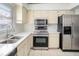Well-lit kitchen with stainless steel appliances and ample counter space at 1009 Hardwood Dr, Valrico, FL 33596