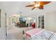 Spacious bedroom featuring a ceiling fan, large windows and a connected living room at 119 W Powhatan Ave, Tampa, FL 33604