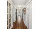 Long hallway with hardwood floors and white trim throughout at 119 W Powhatan Ave, Tampa, FL 33604