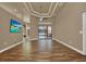 Spacious living room featuring a large window with view of pool, modern flooring, and an open floor plan at 12139 Buckingham Way, Spring Hill, FL 34609