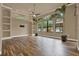 Spacious living room featuring wood floors, abundant natural light, and neutral paint at 12139 Buckingham Way, Spring Hill, FL 34609