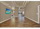 Open living room features stylish tray ceiling and wood floors at 12139 Buckingham Way, Spring Hill, FL 34609